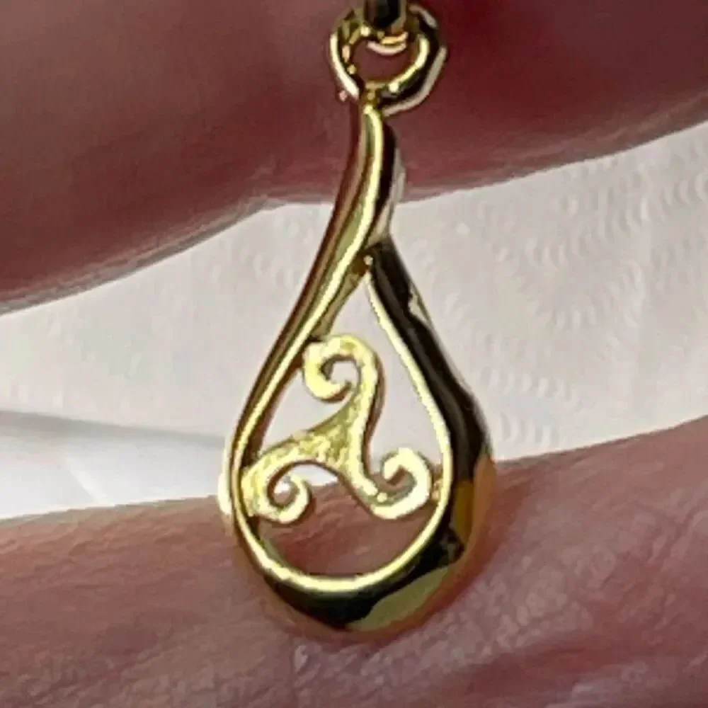 Sterling silver gold plated open work teardrop pendant and chain.